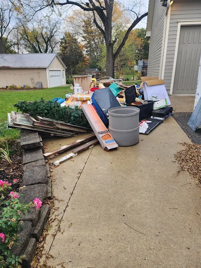 Dumpster being loaded with debris for Estate Cleanout Dumpster Rental in Chesapeake Ranch Estates